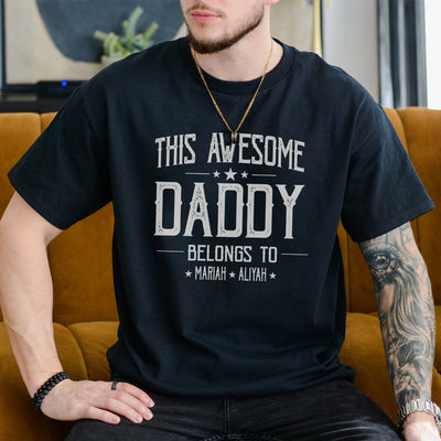 White unisex t-shirt with bold text reading This Awesome Daddy Belongs To with two children's names, dad fathers day gifts idea