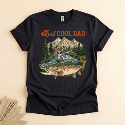 Black funny fishing dad shirt with reel cool dad text and a vintage fly fishing mountain river trout graphic
