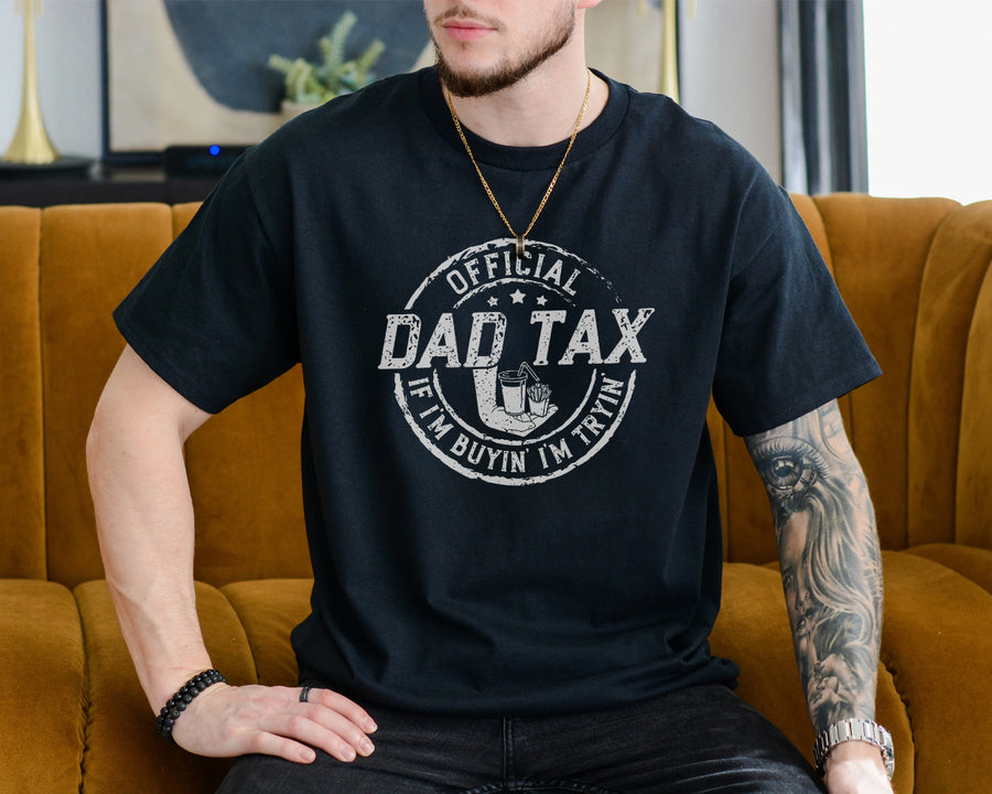 Black unisex t-shirt with distressed stamp graphic reading Official Dad Tax If I'm Buyin' I'm Tryin', dad fathers day gifts idea