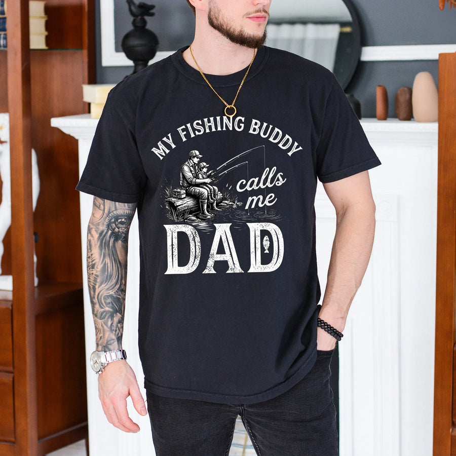 Black t-shirt with fishing buddy calls me dad graphic showing father and child fishing together on a dock