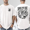 White funny dad shirt with a skeleton sitting on a toilet scrolling a phone, checkerboard background, Doing Dad Shit text