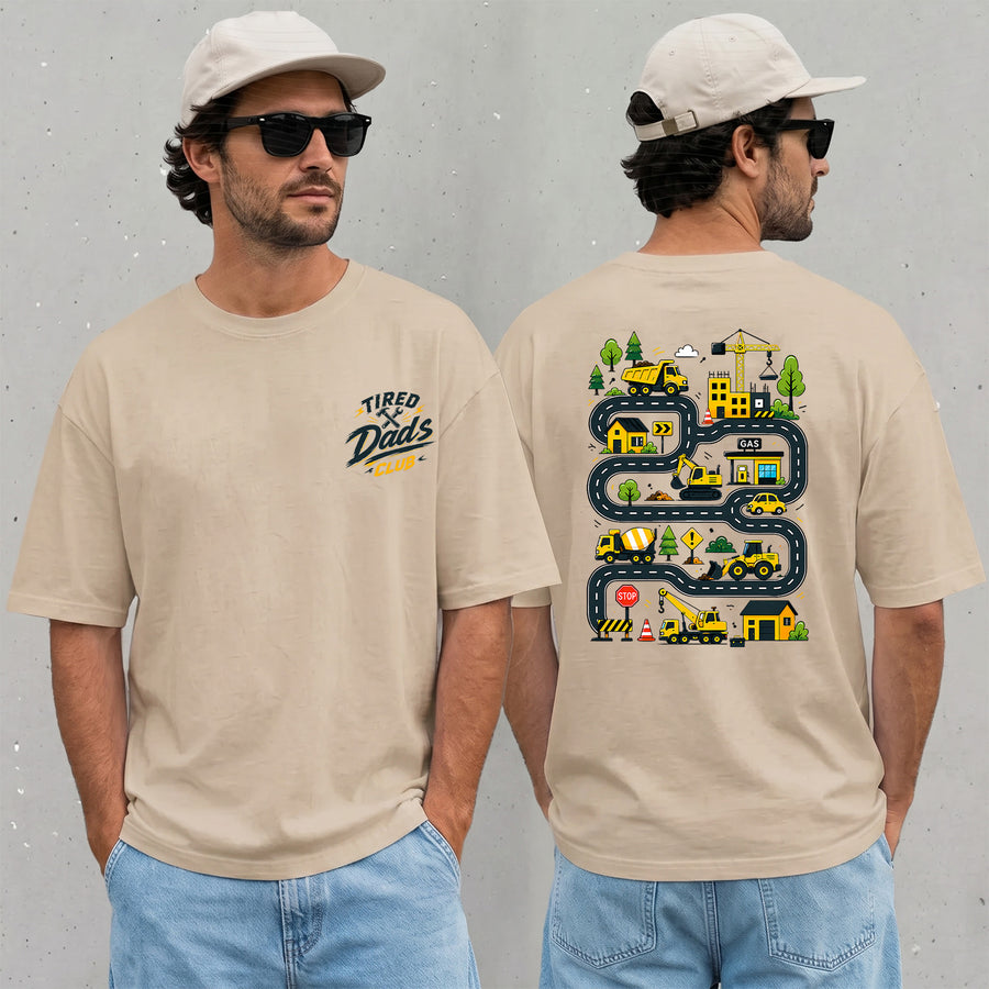 sand unisex funny dad t-shirt with a construction truck road map on the back and Tired Dads Club logo on the chest