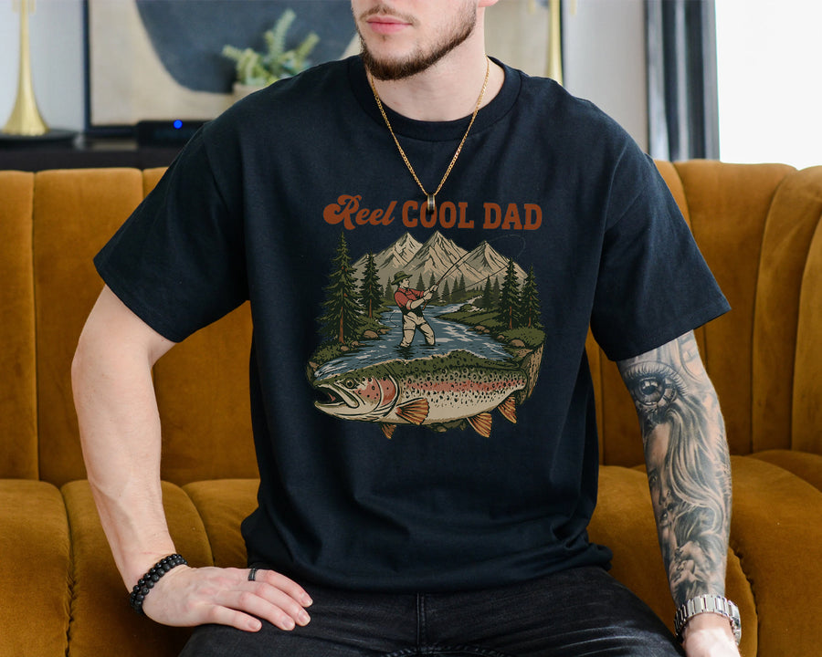 Black funny fishing dad shirt with reel cool dad text and a vintage fly fishing mountain river trout graphic