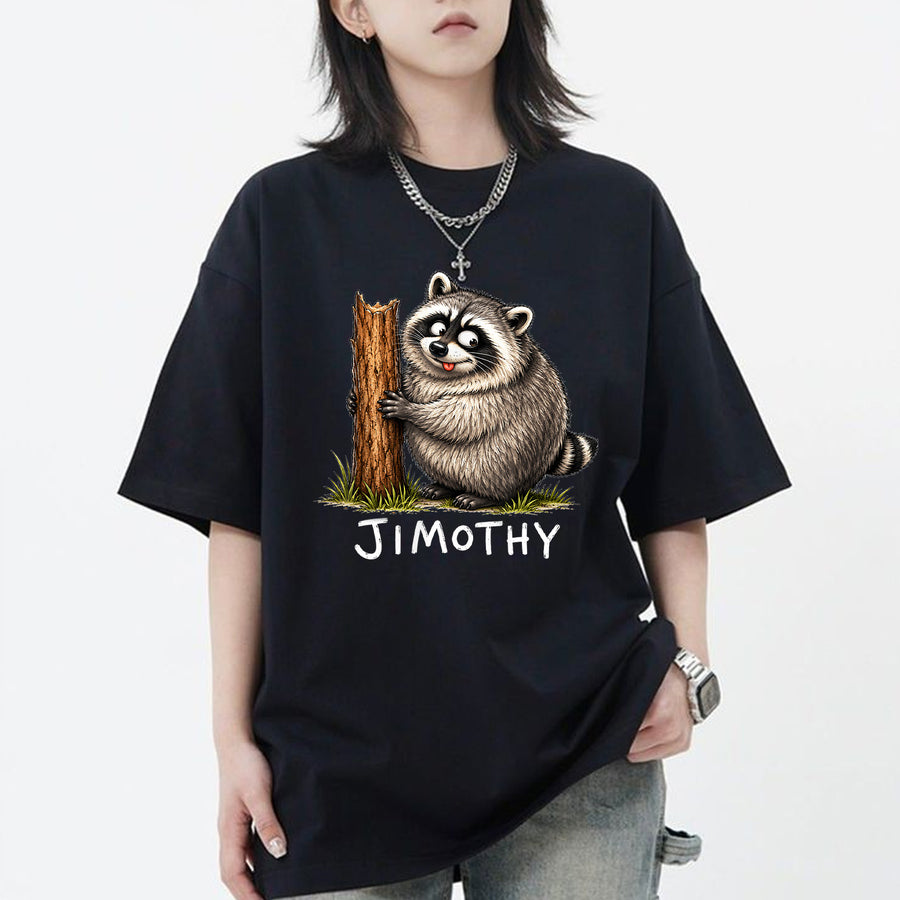 Black unisex funny raccoon graphic tee featuring a chubby cartoon raccoon hugging a tree stump with the name Jimothy below
