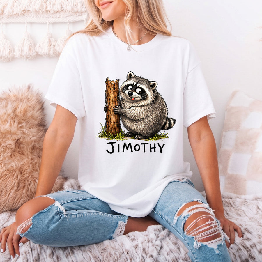 White unisex funny raccoon graphic tee featuring a chubby cartoon raccoon hugging a tree stump with the name Jimothy below