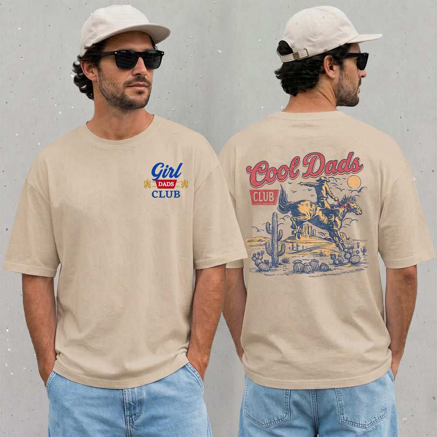 sand unisex girl dad club shirt with vintage cowboy riding horse desert graphic on the back and Girl Dads Club text on the front chest