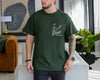 Ivory unisex golf dad shirt with green sketch graphic of a golf club striking a ball and the text Best Dad By Par on the chest