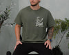 Ivory unisex golf dad shirt with green sketch graphic of a golf club striking a ball and the text Best Dad By Par on the chest