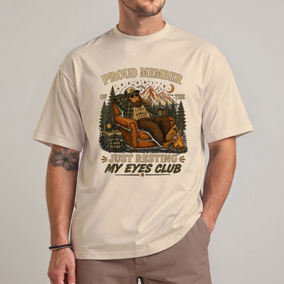 Black Just resting my eyes club shirt featuring a bigfoot dad relaxing in an armchair by a campfire under mountain and night sky scenery