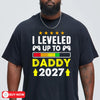 navyunisex t-shirt with leveled up to daddy 2027 gamer design featuring game controllers and a progress bar graphic