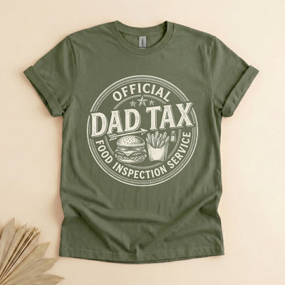 Black unisex t-shirt with vintage badge graphic reading Official Dad Tax Food Inspection Service with burger and fries illustration