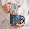 Personalized anniversary mug set with custom initials and date inside a carved heart on a tree illustration, cream and blue coarse ceramic