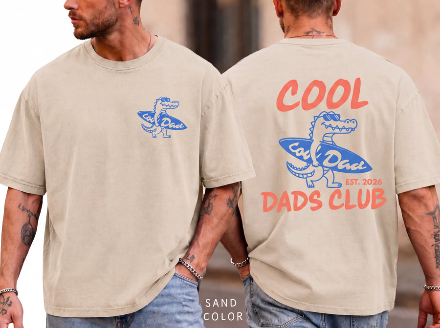 Ivory unisex t-shirt front and back with personalized cool dads club surf alligator graphic in blue and coral, est. 2026 text