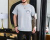 Ivory unisex t-shirt with a trout illustration and the words Reel Cool Dad plus a custom established year on the chest pocket area