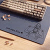 Personalized leather desk mat featuring a custom line art portrait of a father and child drawn from a photo, with the message 'I love you Daddy, James'
